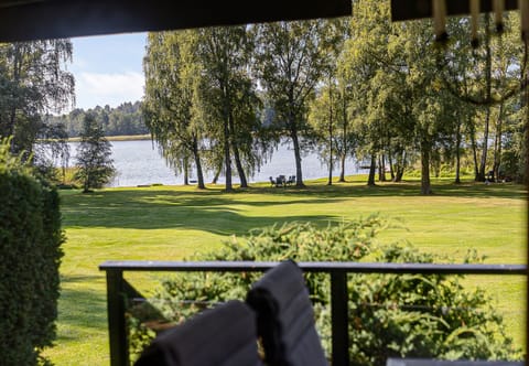 View from the house over the large grass area down to the private beach with jetty