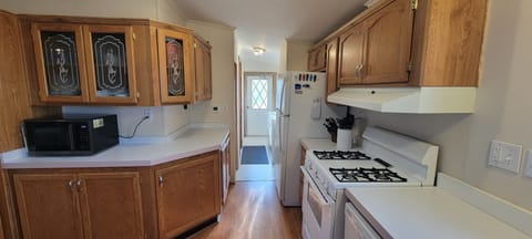 Rear-side entry with laundry and work area.