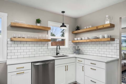 A deep sink with garbage disposal and dishwasher makes cleaning up a breeze.