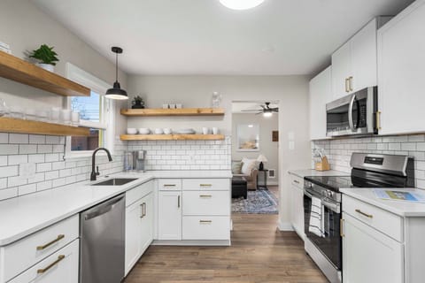 Our newly refreshed kitchen. Featuring floating shelves and new appliances!