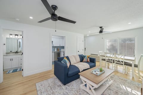 Open layout with stylish furniture and calming coastal inspired color palette.