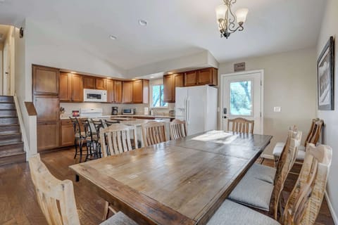 Gather around the large dining table for meals, games, or conversations—seamlessly connected to the kitchen and living area for easy entertaining. 