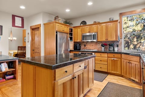The warm, open kitchen offers ample space & every home comfort