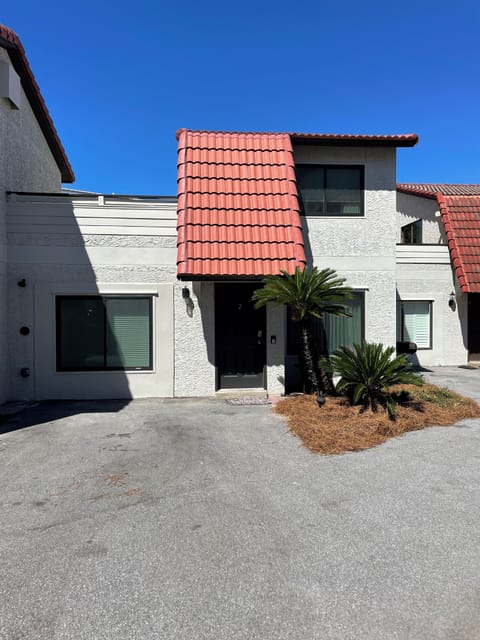 Front of the townhouse which has an outdoor shower, and dedicatedparking