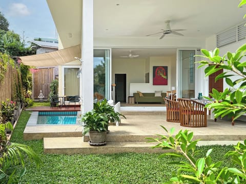 Ground floor: open living space with patio, pool, lush garden and family room