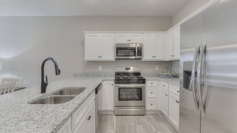 Modern kitchen featuring stainless steel appliances, granite countertops, and ample cabinet space—perfect for family meals and entertaining.