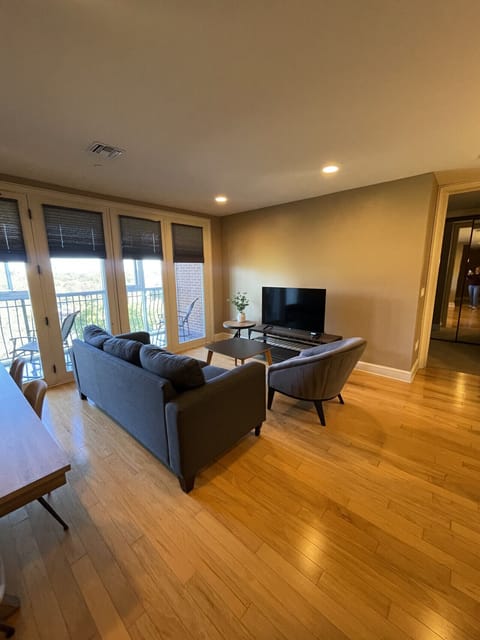 Enjoy cozy evenings in this stylish living room with natural light and a private balcony — part of The Gateway Village’s fully furnished apartments in the heart of Murfreesboro, ideal for extended stays.