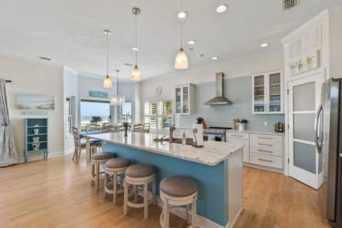 Large gourmet kitchen with island seating and stainless steel appliances