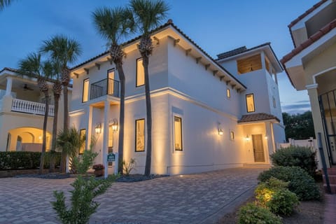 Spacious vacation home with professional landscaping and a large driveway for convenient parking.