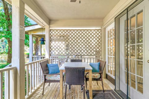 Enjoy morning coffee or evening meals on the covered back deck. Seats four with wicker chairs and a white table, plus a lattice privacy screen for a shaded, secluded outdoor experience.
