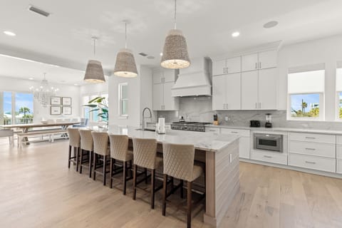 Cook memorable meals in this spacious gourmet kitchen featuring marble countertops, professional appliances, and a large island where you'll gather with loved ones.