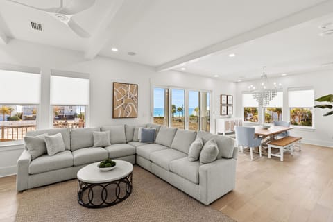 Relax in your bright, open living space where coastal elegance meets comfort. Ocean breezes flow through expansive windows as you enjoy stunning views.