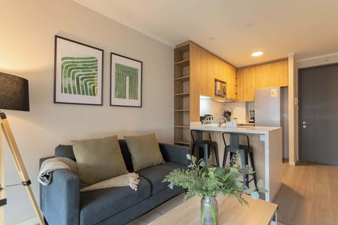 Cozy living space with modern kitchen and stylish decor, perfect for a relaxing stay.