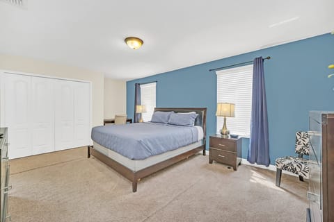 Sink into comfort at the end of the day in this welcoming king bedroom, featuring a plush king bed, flat-screen TV, high-speed Wi-Fi, and a relaxing setting designed for a great night's sleep.