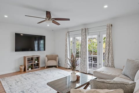 Living room with sectional couch and 75 inch smart TV