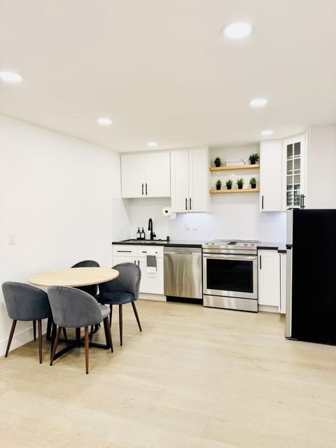 Open kitchen layout with a dishwasher, electric range, refrigerator.