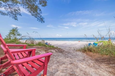 Incredible backyard with your feet in the sand, featuring comfortable outdoor furniture, a pool table for added fun, and a cozy gazebo. Plus, enjoy breathtaking views of the beach and Indian Shores.