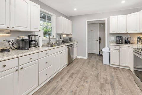 A vacation kitchen you can really cook in: dinnerware for 16, Dishwasher, Spice Rack, Ninja Air Fryer, Bullet Blender & Coffee Maker & Keurig coffee maker, Food processor, Microwave, Big fridge & freezer with craft ice maker w/ clear spheres of ice!