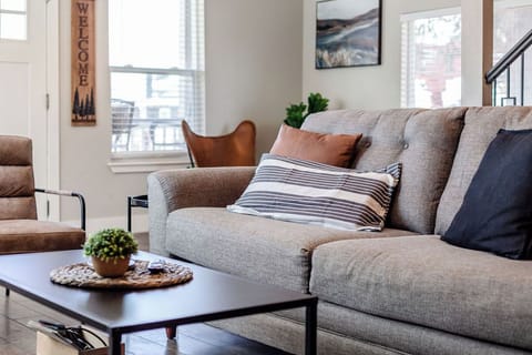 Enjoy our thoughtfully designed living room with comfy couch and ample seating