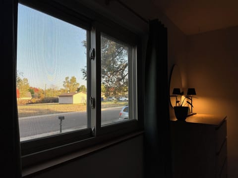 King room facing the front yard. View of the quiet empty lot across the street.