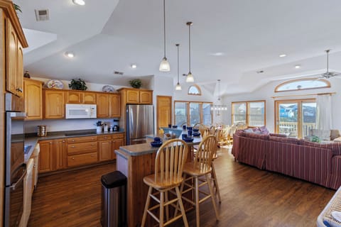 Kitchen - Large windows with natural light amplify the high ceilings in the home's large kitchen.
