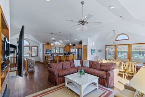 Living Room - Large windows with natural light amplify the high ceilings in the home's open living spaces.
