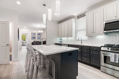 A kitchen that inspires with its warm hardwood floors and gorgeous granite countertops.