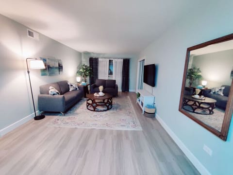 This living room, complete with stylish furniture and a stunning flat-screen TV, is designed for both comfort and enjoyment. Let the good times roll!