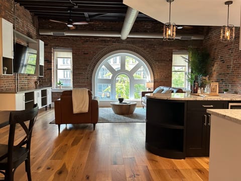 Luxurious open floor plan with 10' window and exposed historic brick & plaster