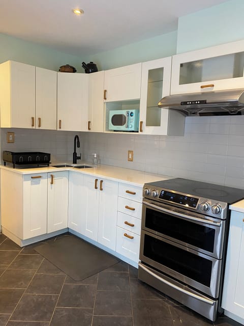 Super deep corner sink with Moen Faucet & brand new Insignia Retro microwave.