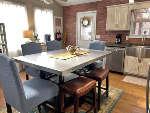 The dining table seats 6.  Cutting board and baking dishes are stored here.