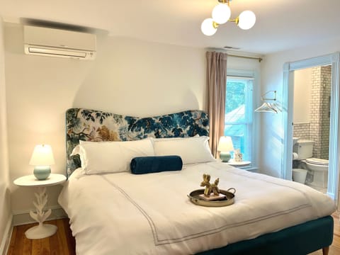 Room 5: Mint green accents, King Anthropologie Velvet Bed, 45" Smart TV, marble bath with glass enclosed shower