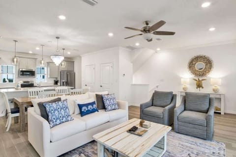 Spacious living room featuring ample seating, a smart TV, and access to a screened-in patio for relaxed gatherings.