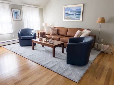 Living room with large (101 inch wide) sofa and swivel chairs