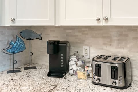 Coffee bar with cream and sweetener options. Coffee pods are provided for single cup servings.