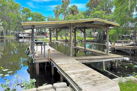 Covered dock, can accommodate 3 boats; depending on size.