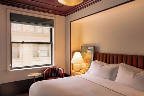 Wake up in crisp linens with calming daylight by the window.
