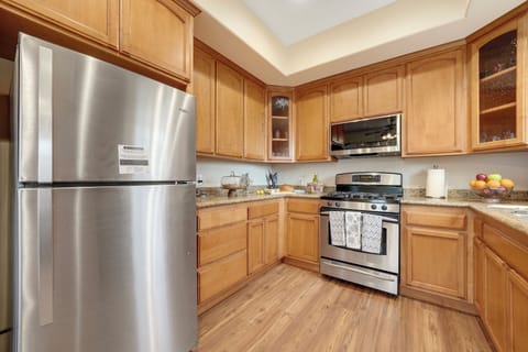 Kitchen view with the refrigerator on left side.