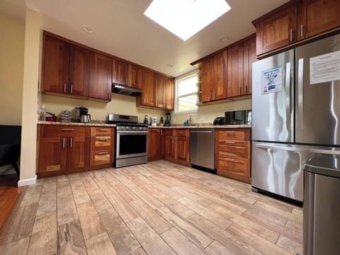 Kitchen features a stove/oven, large sink, refrigerator, and other appliances.