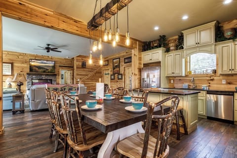 Smoky Mountain Vacation Rental “The Manor at Burg Hill” – Dining area, fully furnished kitchen, and living room.