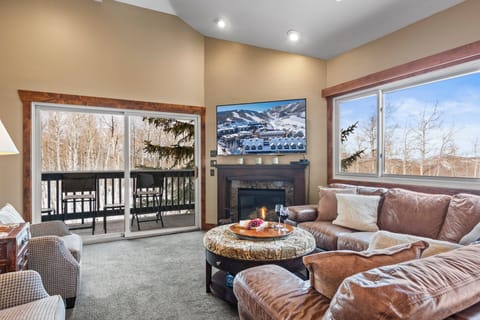 Snow Flower 123 offers a spacious living room with flat screen TV and gas burning fireplace.