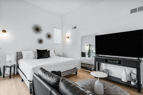 Studio bedroom featuring a comfy king bed, separate dining area, kitchenette, private bath, and outdoor space.