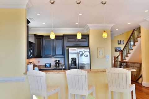 Counter tops with high chairs on the kitchen area