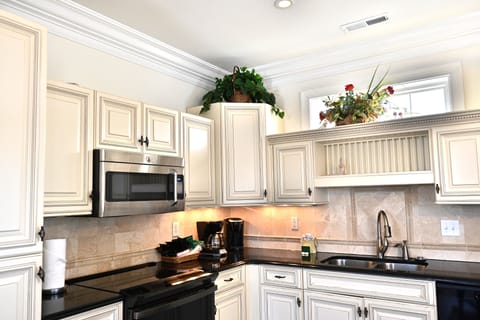 Modern kitchen with stainless steel appliances and charm
