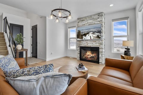 Living room on main floor off kitchen with fireplace, TV, and amazing views
