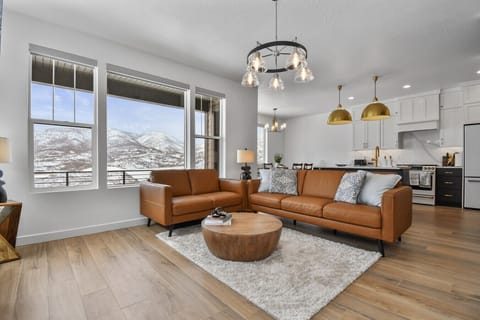 Living room on main floor off kitchen with fireplace, TV, and amazing views