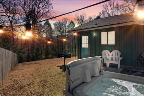 Relax in the bubbling hot tub overlooking the peaceful backyard.
