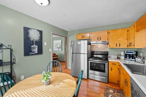 There is a dining table that seats four as well as stainless steel appliances and a dual coffeemaker.