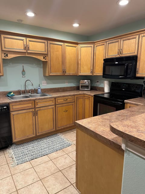 Large kitchen with all of the cooking utensils, pots/pans and baking dishes. 