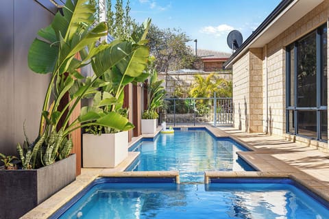 Relax by the heated pool and spa; the kids playing with the provided pool toys
